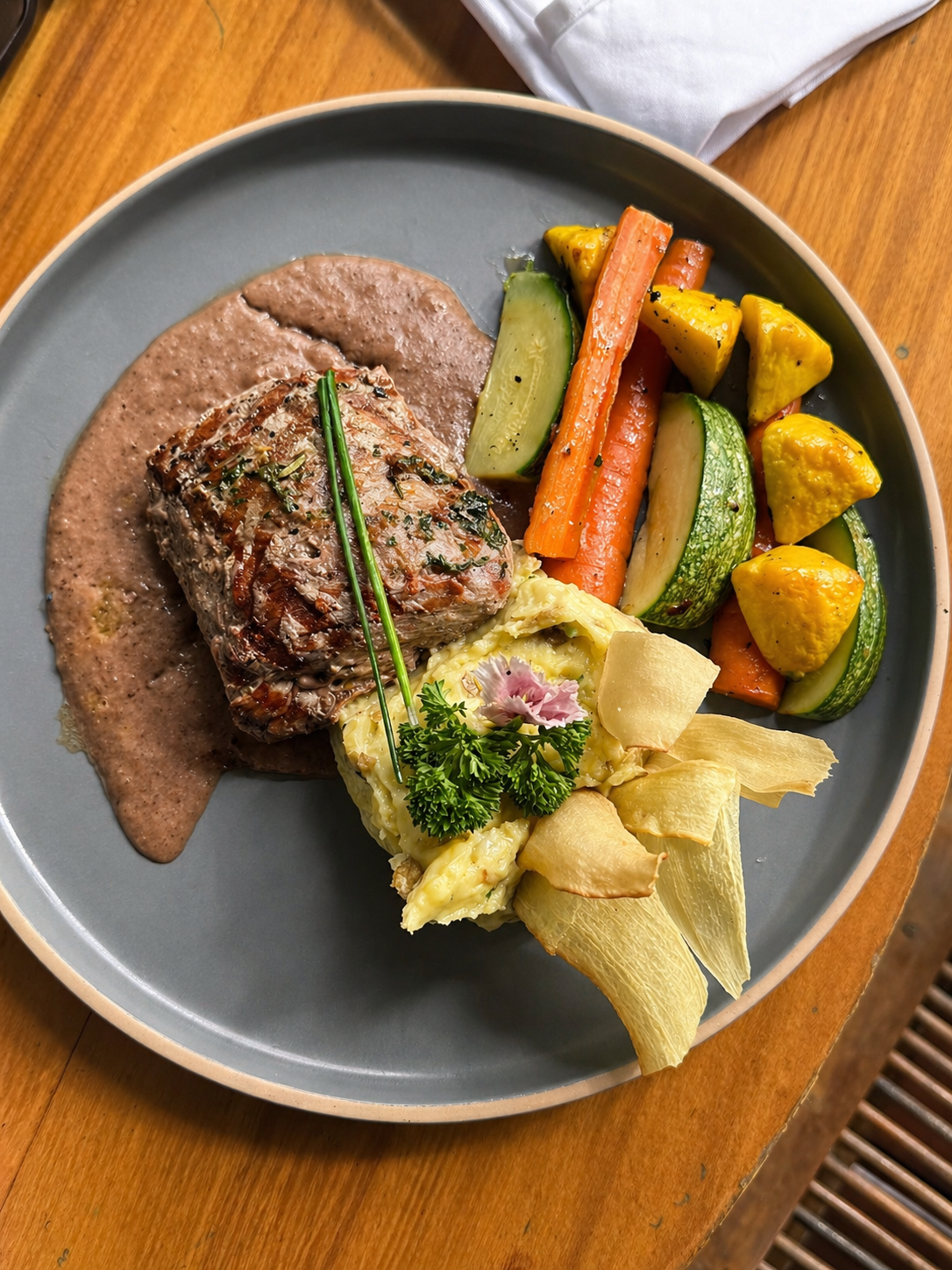 Plated tenderloin with seasonal vegetables.