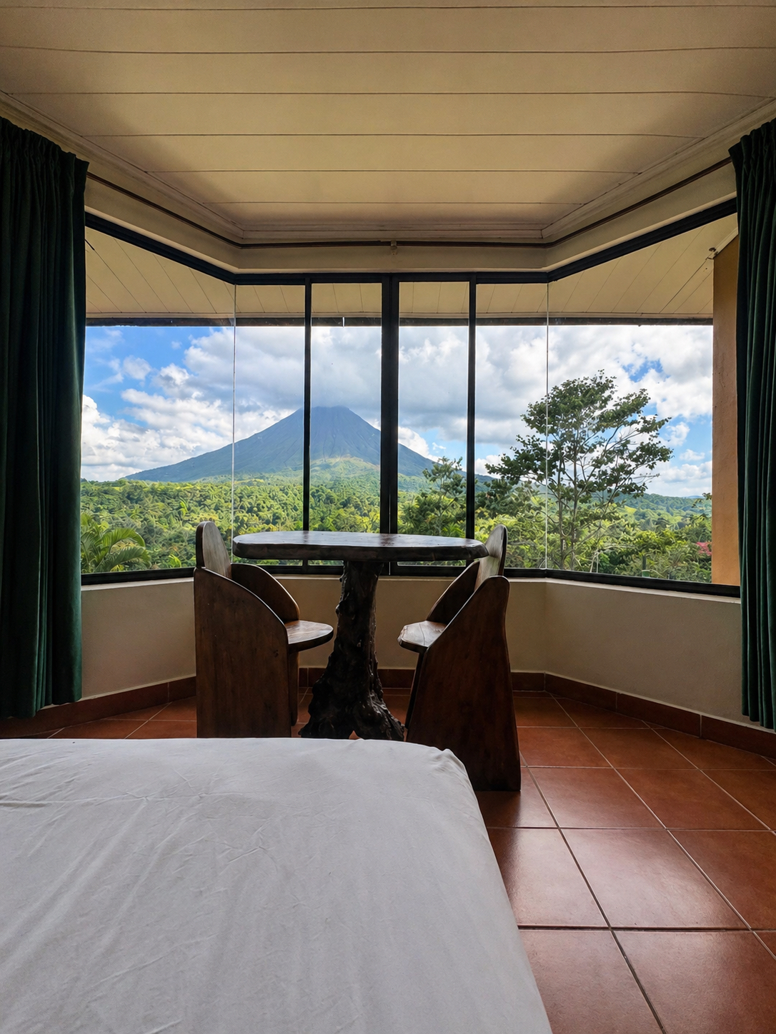 A standard room with a direct view of Arenal Volcano from inside the suite.