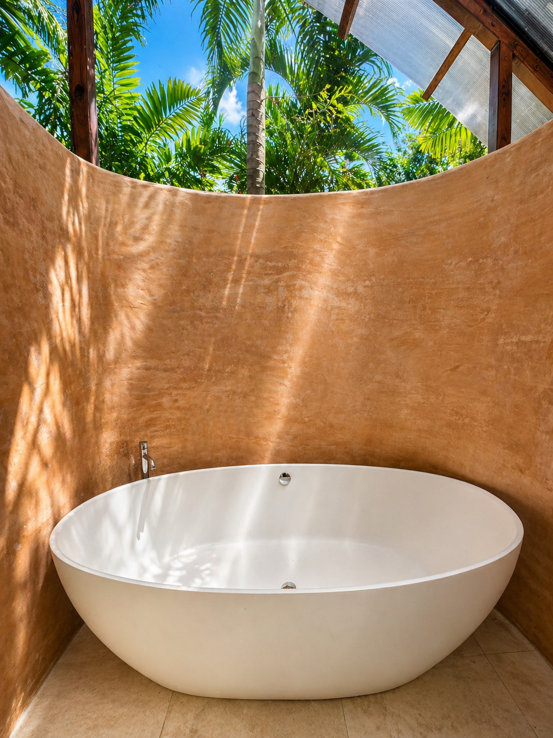 Outdoor sculptural soaking tub open to the canopy.